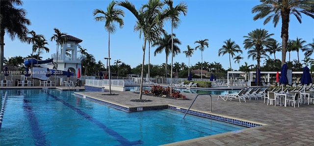 pool with fence and a patio