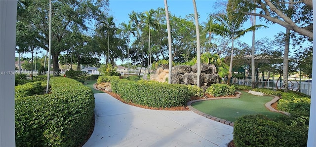 view of home's community featuring fence