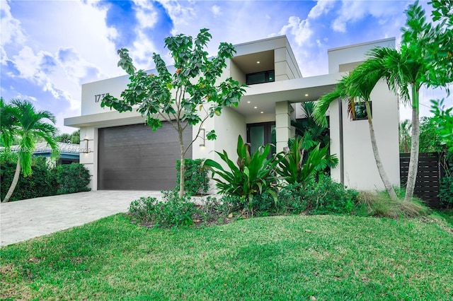 1733 NE 16th Ter, Fort Lauderdale, FL 33305 - modern home with a garage, driveway, a front yard, and stucco siding