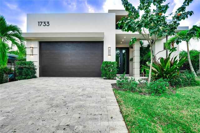 1733 NE 16th Ter, Fort Lauderdale, FL 33305 - modern home with stucco siding and decorative driveway