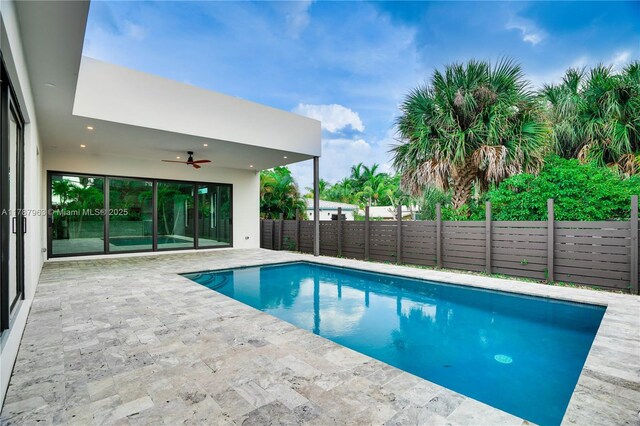 1733 NE 16th Ter, Fort Lauderdale, FL 33305 - view of swimming pool featuring a patio area, a fenced backyard, a ceiling fan, and a fenced in pool