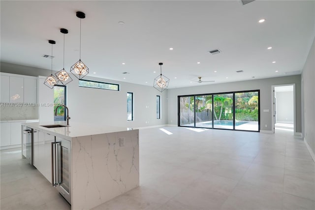 1733 NE 16th Ter, Fort Lauderdale, FL 33305 - kitchen with a sink, modern cabinets, white cabinets, visible vents, and recessed lighting