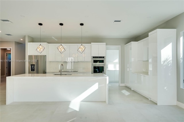 1733 NE 16th Ter, Fort Lauderdale, FL 33305 - kitchen featuring white cabinets, appliances with stainless steel finishes, a sink, and visible vents