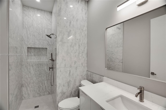1733 NE 16th Ter, Fort Lauderdale, FL 33305 - full bathroom featuring tile walls, toilet, vanity, and a walk in shower