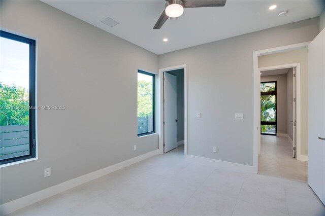 1733 NE 16th Ter, Fort Lauderdale, FL 33305 - empty room featuring a healthy amount of sunlight, baseboards, ceiling fan, and visible vents