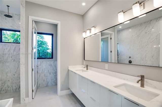 1733 NE 16th Ter, Fort Lauderdale, FL 33305 - bathroom featuring recessed lighting, double vanity, walk in shower, and a sink