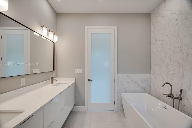 1733 NE 16th Ter, Fort Lauderdale, FL 33305 - full bath featuring tile patterned floors, a sink, double vanity, tile walls, and a freestanding tub