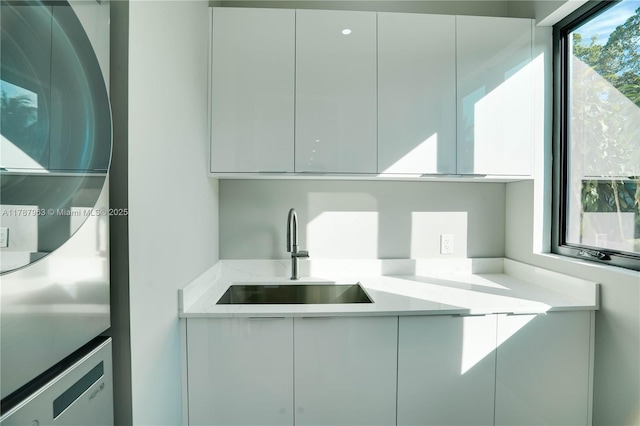 1733 NE 16th Ter, Fort Lauderdale, FL 33305 - kitchen featuring modern cabinets, white cabinets, light stone countertops, and a sink