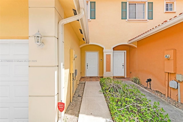 8308 Santa Monica Ave, Tamarac, FL 33321 - doorway to property featuring stucco siding and an attached garage