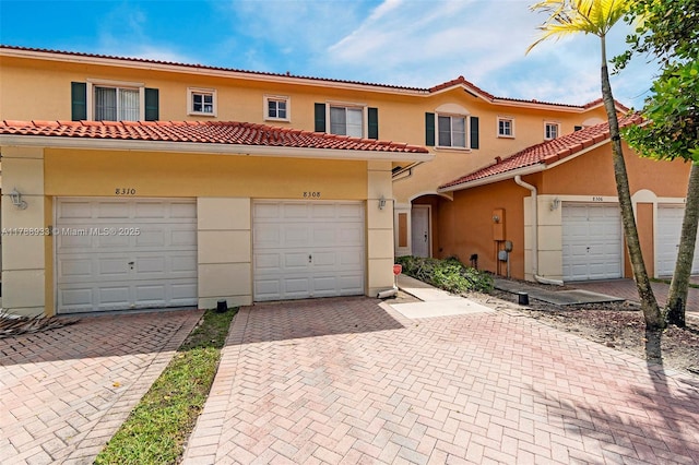 8308 Santa Monica Ave, Tamarac, FL 33321 - view of front of house featuring stucco siding, a tiled roof, and driveway