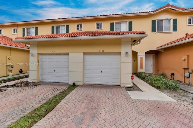 8308 Santa Monica Ave, Tamarac, FL 33321 - view of front facade with stucco siding, decorative driveway, and a tiled roof