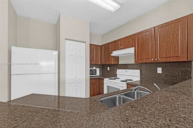 8308 Santa Monica Ave, Tamarac, FL 33321 - kitchen featuring white appliances, under cabinet range hood, a sink, tasteful backsplash, and brown cabinets