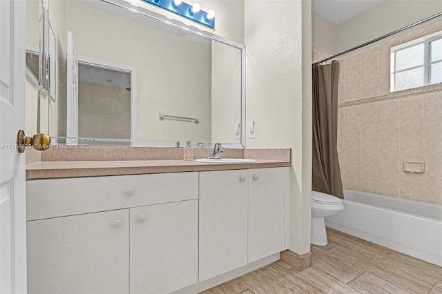 bathroom featuring shower / tub combo with curtain, toilet, and vanity