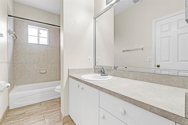 bathroom featuring toilet, visible vents, vanity, and shower / tub combination