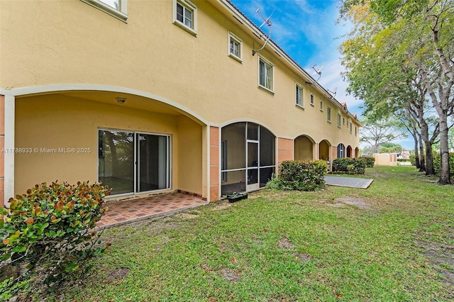 8308 Santa Monica Ave, Tamarac, FL 33321 - back of house featuring stucco siding, a lawn, and a patio area