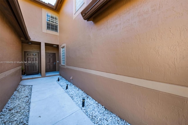 property entrance with stucco siding