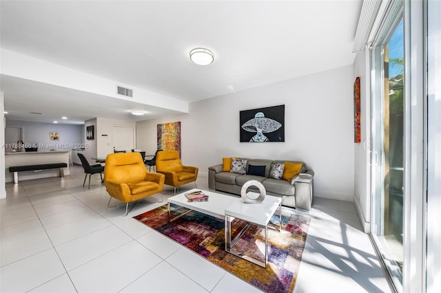 living area with light tile patterned flooring and visible vents