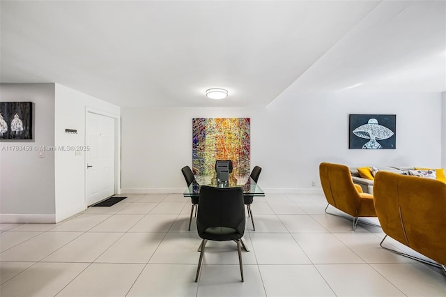 dining room with baseboards and light tile patterned floors