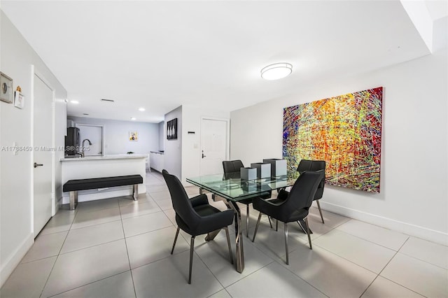 dining space featuring recessed lighting, baseboards, and light tile patterned floors