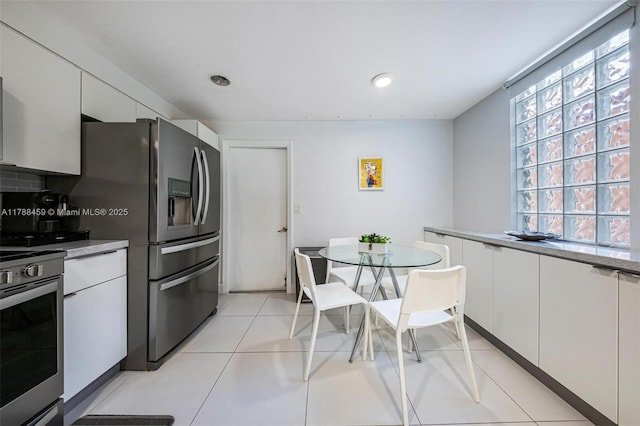 kitchen featuring a healthy amount of sunlight, white cabinetry, and stainless steel appliances