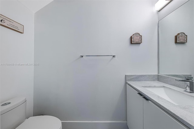 bathroom with toilet and vanity