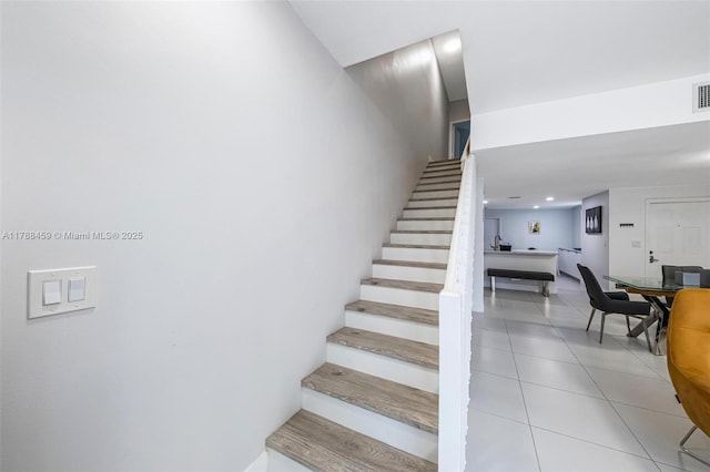 stairs with tile patterned flooring and visible vents