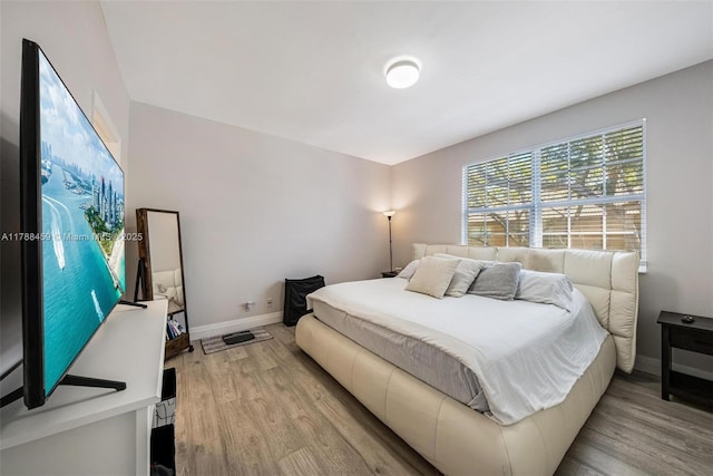 bedroom with wood finished floors and baseboards