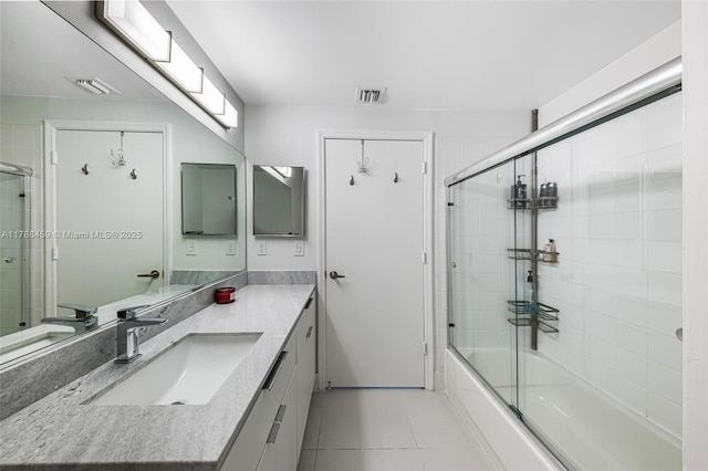 bathroom featuring visible vents, tile patterned flooring, vanity, and enclosed tub / shower combo