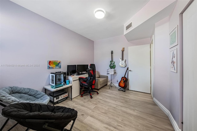 home office featuring baseboards, visible vents, and light wood-type flooring