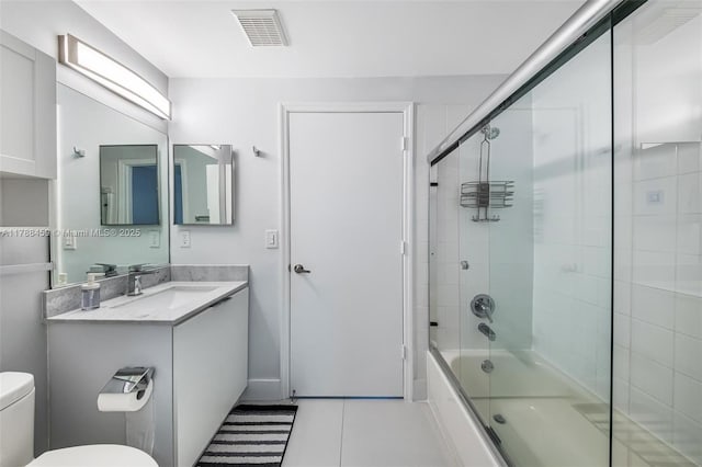 full bathroom featuring vanity, enclosed tub / shower combo, toilet, tile patterned flooring, and visible vents