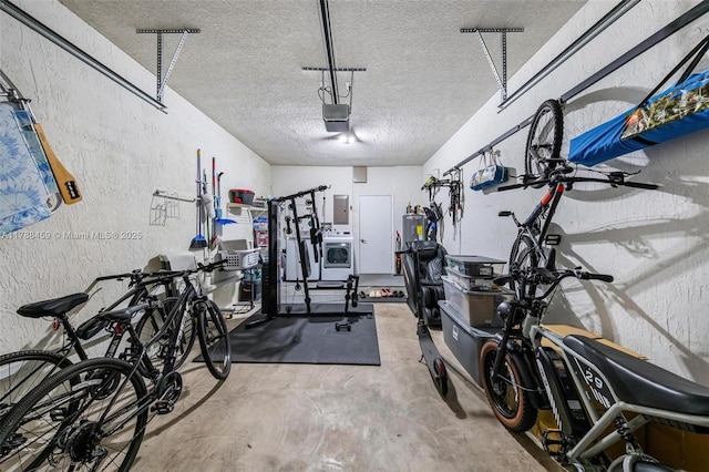 garage with washer / dryer, a textured wall, a garage door opener, and electric panel