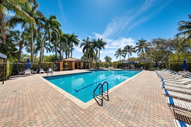 pool featuring fence and a patio area