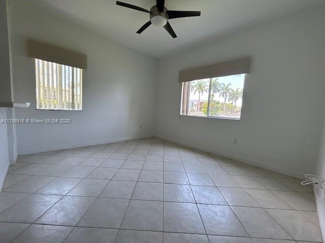 7911 W Exeter Blvd W Unit A101, Tamarac, FL 33321 - unfurnished room with light tile patterned floors, a ceiling fan, and baseboards