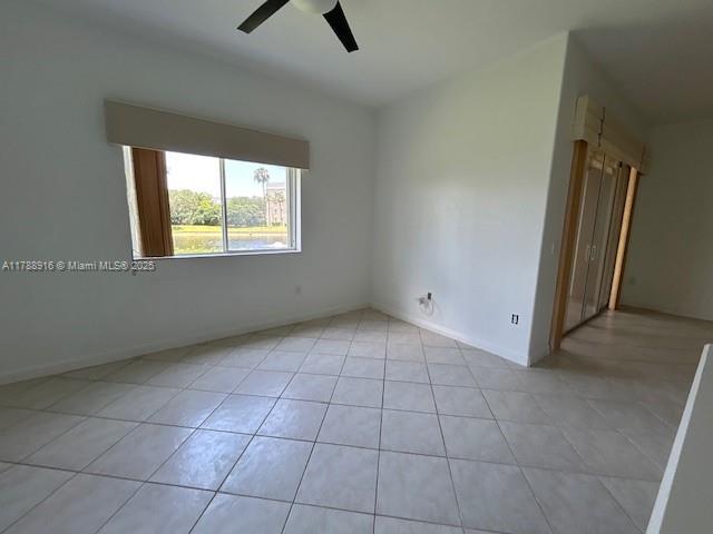 7911 W Exeter Blvd W Unit A101, Tamarac, FL 33321 - unfurnished room featuring a ceiling fan, light tile patterned floors, and baseboards