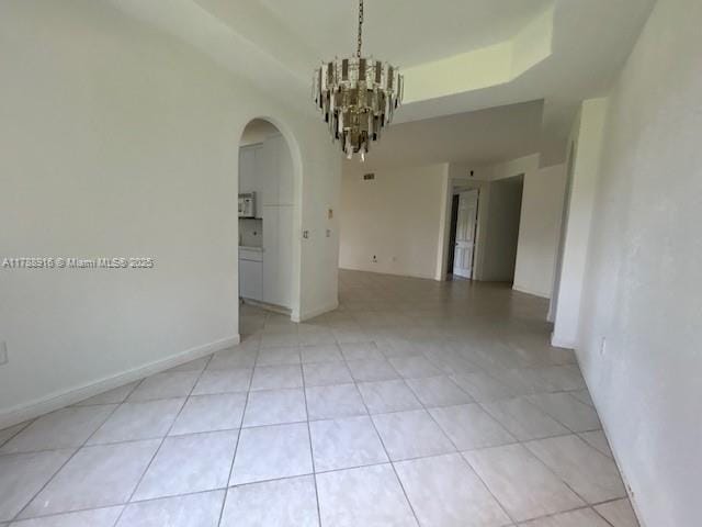 7911 W Exeter Blvd W Unit A101, Tamarac, FL 33321 - empty room with arched walkways, a chandelier, and light tile patterned floors