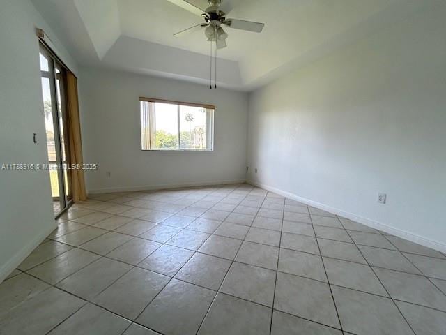 7911 W Exeter Blvd W Unit A101, Tamarac, FL 33321 - unfurnished room featuring a raised ceiling, light tile patterned floors, a ceiling fan, and baseboards