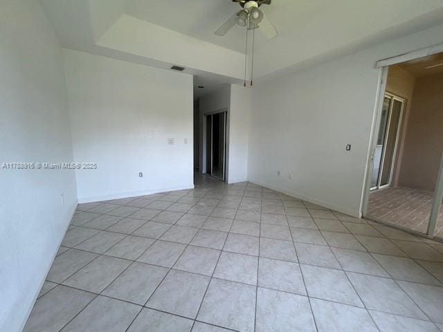 7911 W Exeter Blvd W Unit A101, Tamarac, FL 33321 - spare room featuring light tile patterned floors, ceiling fan, and a raised ceiling