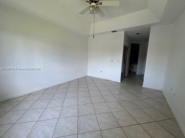 7911 W Exeter Blvd W Unit A101, Tamarac, FL 33321 - unfurnished room with a ceiling fan, light tile patterned flooring, and a tray ceiling
