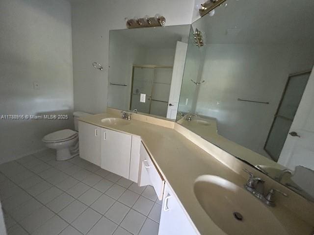 7911 W Exeter Blvd W Unit A101, Tamarac, FL 33321 - bathroom with tile patterned flooring, double vanity, toilet, and an enclosed shower