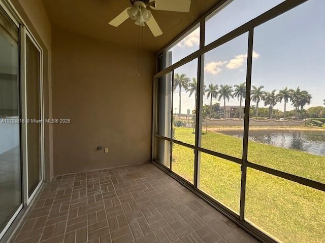 7911 W Exeter Blvd W Unit A101, Tamarac, FL 33321 - unfurnished sunroom featuring ceiling fan, a water view, and healthy amount of natural light