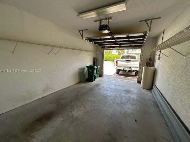 7911 W Exeter Blvd W Unit A101, Tamarac, FL 33321 - garage featuring a garage door opener and a textured wall