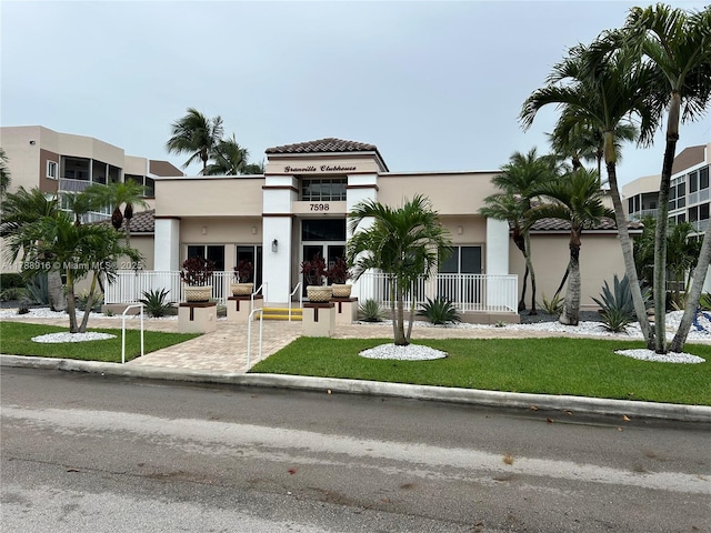 7911 W Exeter Blvd W Unit A101, Tamarac, FL 33321 - view of front of home with stucco siding and a front yard