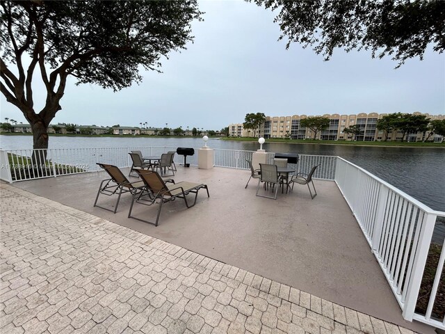 7911 W Exeter Blvd W Unit A101, Tamarac, FL 33321 - view of patio / terrace with a water view and outdoor dining space