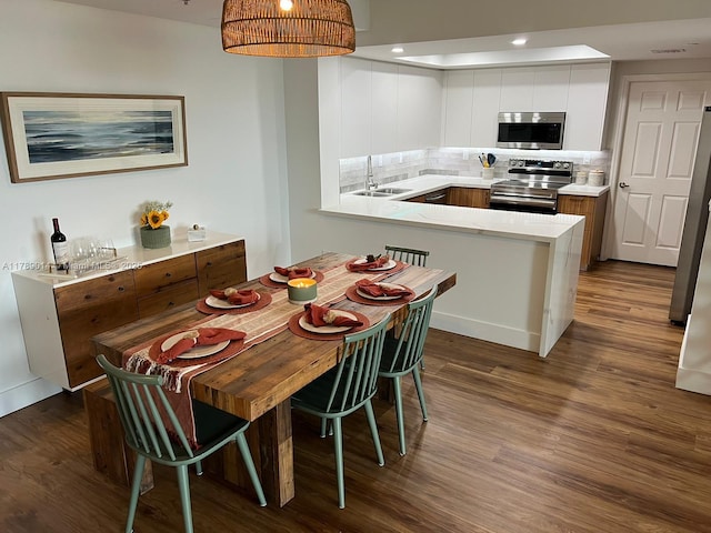 dining room featuring recessed lighting and dark wood finished floors