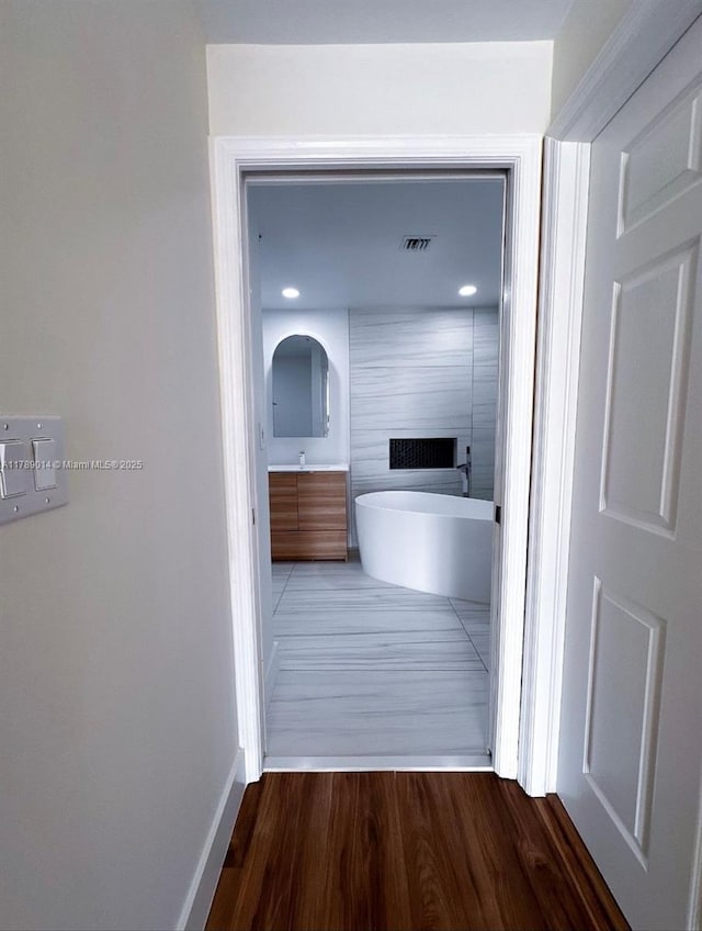 interior space with recessed lighting, visible vents, and wood finished floors