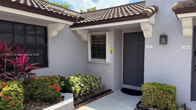 11657 NW 11th St, Pembroke Pines, FL 33026 - view of exterior entry featuring a tiled roof and stucco siding