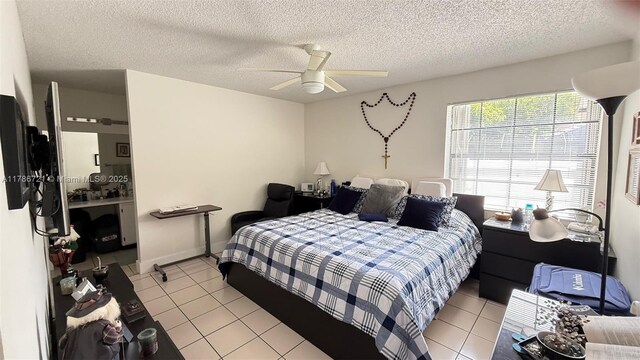 11657 NW 11th St, Pembroke Pines, FL 33026 - bedroom featuring light tile patterned flooring, ceiling fan, and a textured ceiling