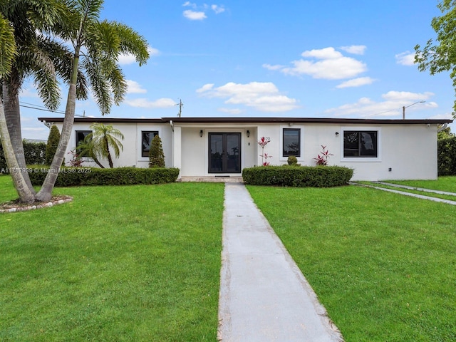 single story home featuring a front lawn, french doors, and stucco siding