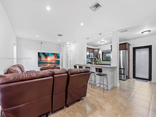 living room with visible vents and recessed lighting
