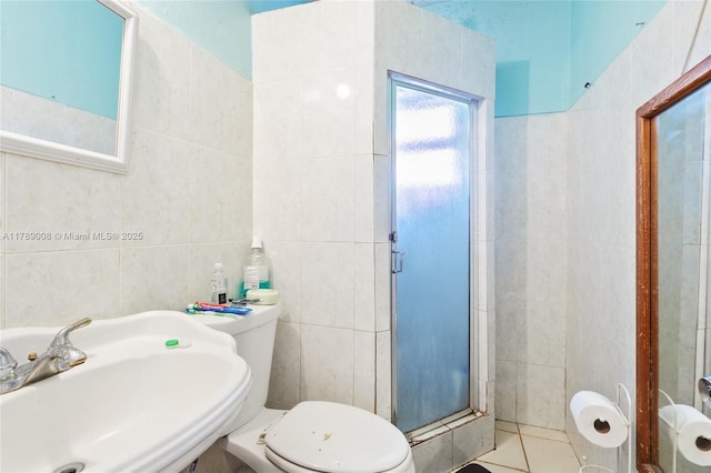 1679 NE 181st St, North Miami Beach, FL 33162 - full bath with tile patterned floors, a sink, a stall shower, tile walls, and toilet